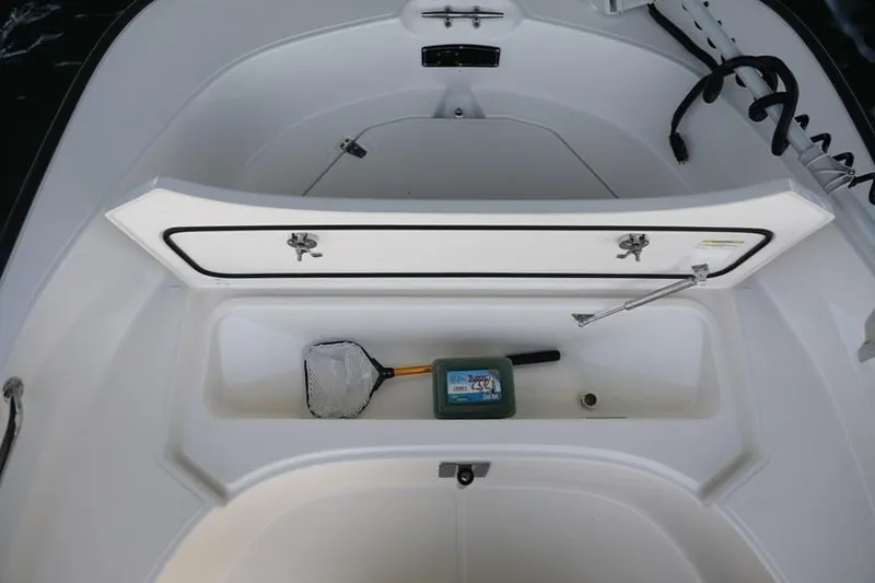 Slide: The Image of Manufacturer Provided Image: Boston Whaler 170 Montauk 2020 model storage compartment with fishing net and tackle box. - 14