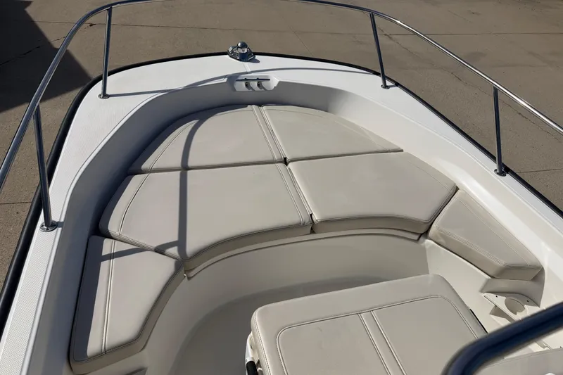 Slide: The Image of 2020 Boston Whaler 170 Montauk boat interior with cushioned seating and railings. - 4