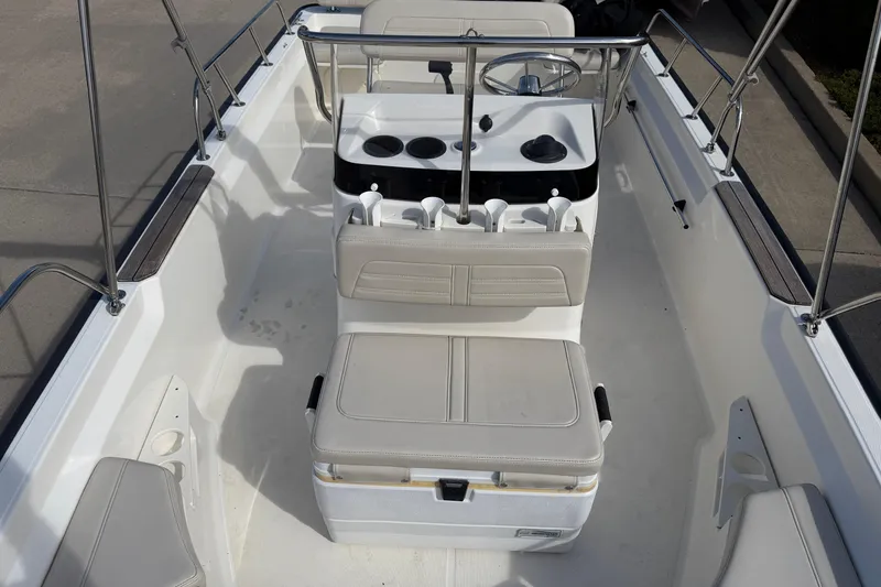 Slide: The Image of 2020 Boston Whaler 170 Montauk boat interior with seating and steering console. - 5