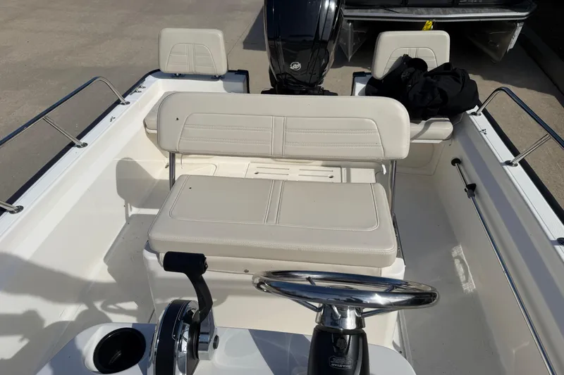 Slide: The Image of 2020 Boston Whaler 170 Montauk boat interior with steering wheel and seating. - 6