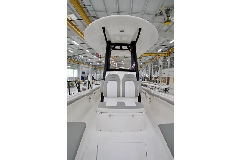 Slide: The Image of 2026 Regulator 23 boat interior with seating in a manufacturing facility. - 10