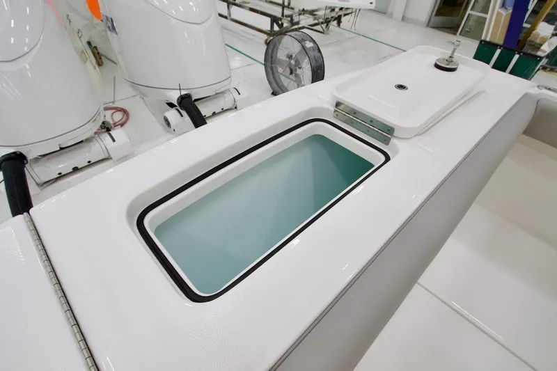 Slide: The Image of 2026 Regulator 23 boat with open storage compartment and dual outboard motors. - 18