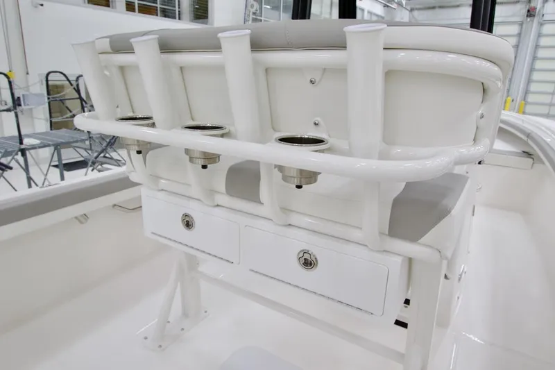 Slide: The Image of 2026 Regulator 23 boat interior with rod holders and storage compartments. - 19