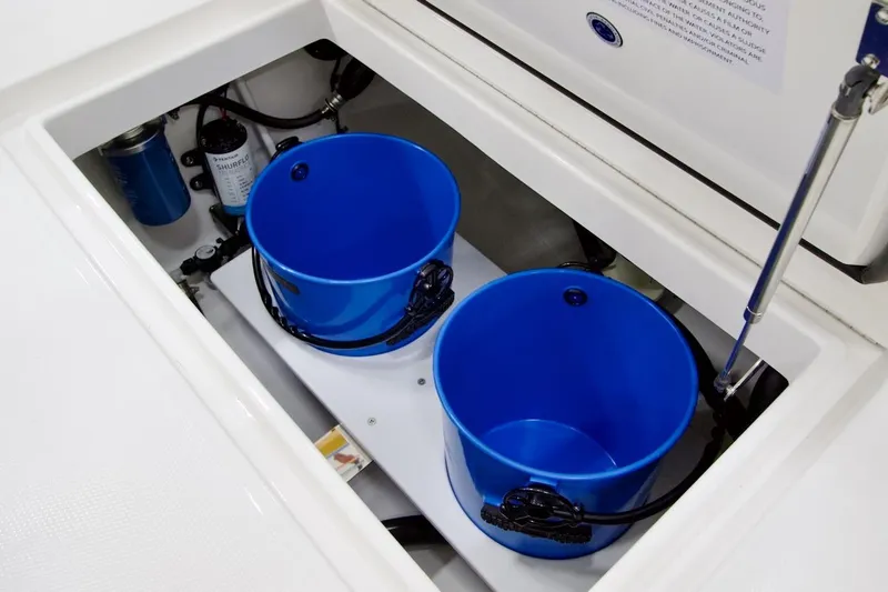 Slide: The Image of Storage compartment with blue buckets on a 2026 Regulator 23 boat. - 20