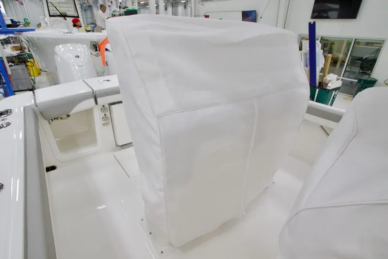 Slide: The Image of 2026 Regulator 23 boat interior with covered seating in a manufacturing facility. - 23