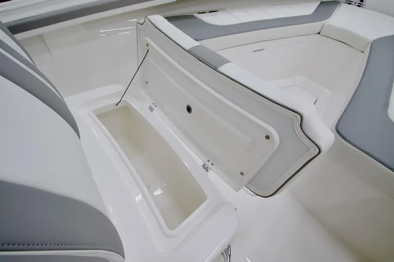 Slide: The Image of 2026 Regulator 23 boat interior with open storage compartment and cushioned seating. - 28