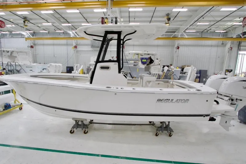 Slide: The Image of 2026 Regulator 23 boat in a manufacturing facility, side view. - 3