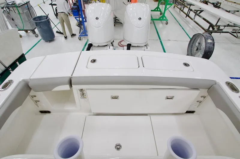 Slide: The Image of 2026 Regulator 23 boat interior with dual engines in a manufacturing facility. - 32