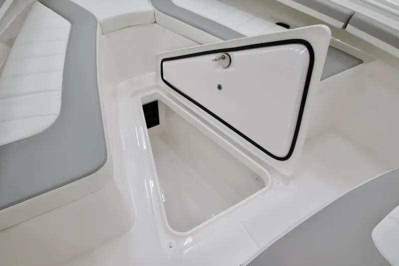 Slide: The Image of 2026 Regulator 23 boat interior storage compartment with cushioned seating. - 8