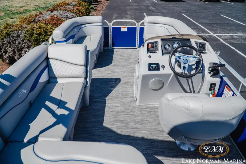Slide: The Image of Interior view of a 2021 Bennington 188 SVL pontoon boat with plush seating and steering console. - 5
