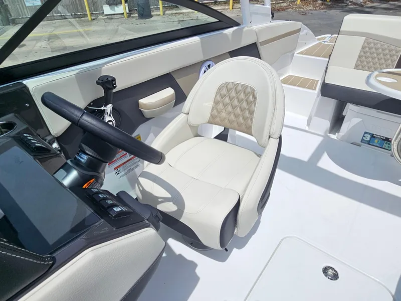 Slide: The Image of 2025 Monterey M-225 boat interior with beige seating and modern steering console. - 14