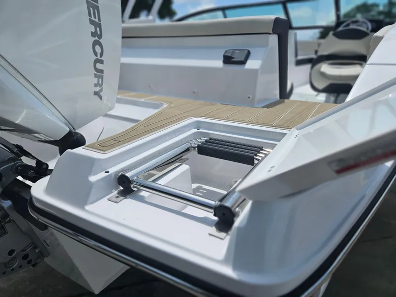 Slide: The Image of 2025 Monterey M-225 boat with open storage compartment and Mercury engine. - 4