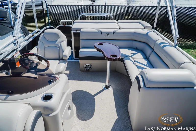 Slide: The Image of 2013 Berkshire 190CL pontoon boat interior with plush seating and steering console. - 16