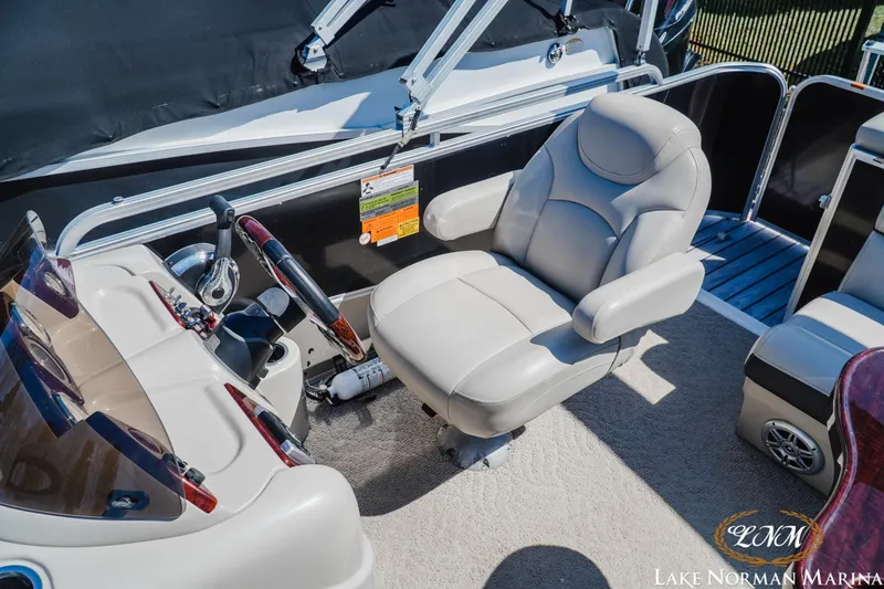 Slide: The Image of Captain's chair and helm of 2013 Berkshire 190CL boat at Lake Norman Marina. - 17