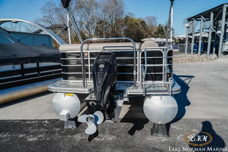 Slide: The Image of 2013 Berkshire 190CL pontoon boat at Lake Norman Marina, rear view with motor. - 3
