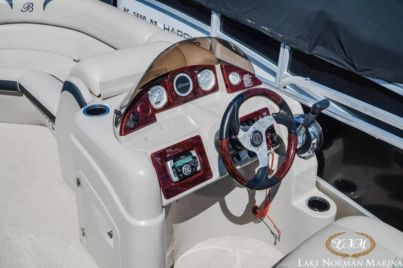 Slide: The Image of 2013 Berkshire 190CL boat dashboard with steering wheel and controls at Lake Norman Marina. - 9