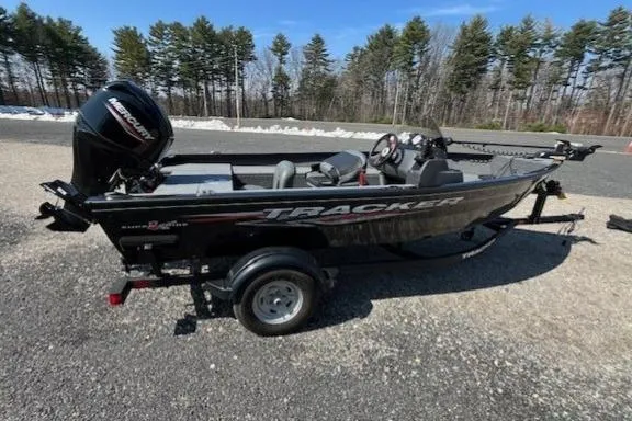 Slide: The Image of 2025 Tracker Super Guide V-16 SC fishing boat on trailer, parked outdoors. - 4
