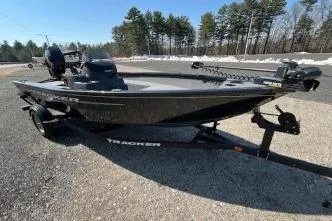 Slide: The Image of 2025 Tracker Super Guide V-16 SC fishing boat on trailer, parked outdoors. - 6