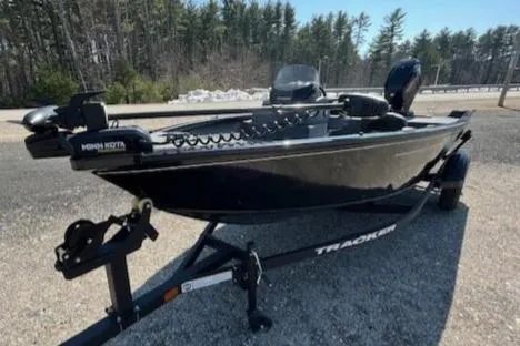 Slide: The Image of 2025 Tracker Super Guide V-16 SC boat on trailer, parked outdoors. - 7