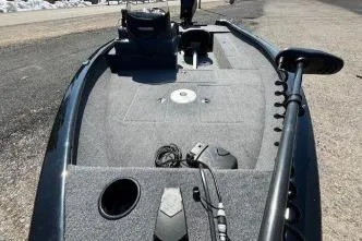 Slide: The Image of 2025 Tracker Super Guide V-16 SC fishing boat deck with trolling motor and storage compartments. - 8