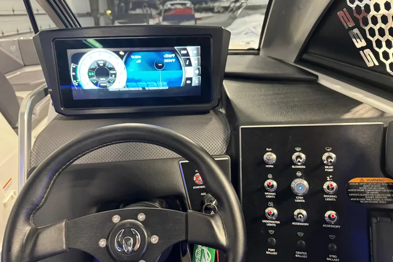 Slide: The Image of Dashboard of a 2021 Scarab 285 ID boat with digital display and control panel. - 14