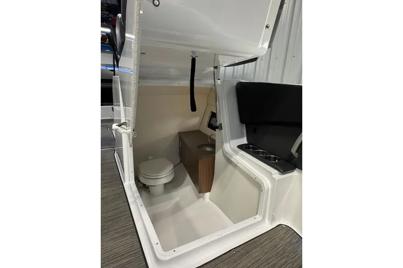 Slide: The Image of 2021 Scarab 285 ID boat interior with toilet and storage area. - 16
