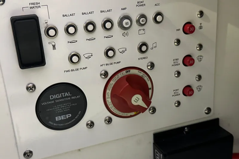 Slide: The Image of Control panel of a 2021 Scarab 285 ID boat with various switches and dials. - 17