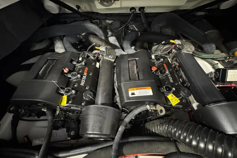 Slide: The Image of Engine compartment of a 2021 Scarab 285 ID boat featuring dual Rotax engines. - 18
