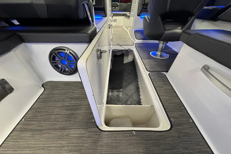 Slide: The Image of 2021 Scarab 285 ID boat interior with open storage compartment and speaker. - 20