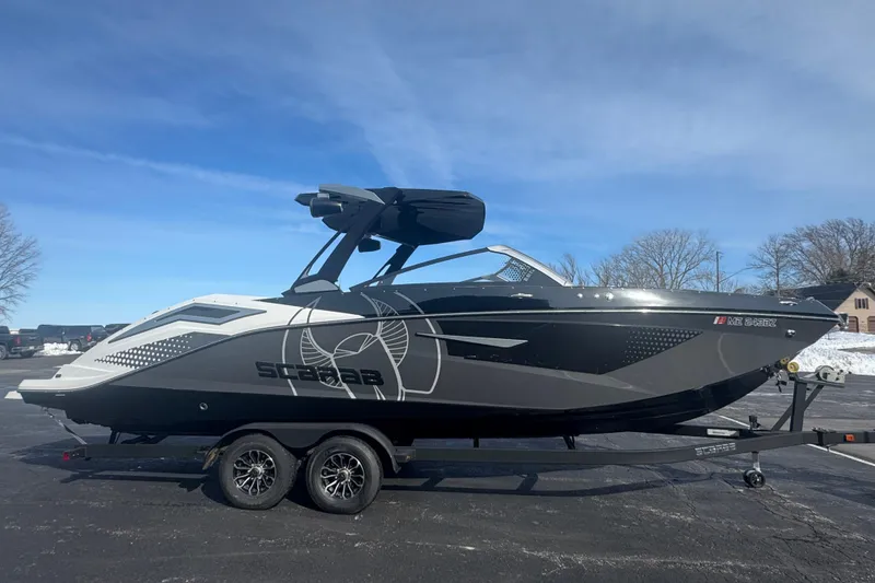 Slide: The Image of 2021 Scarab 285 ID boat on trailer under clear blue sky. - 4
