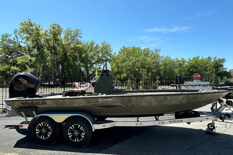 The Image of 2026 Vexus ACX 2000 boat on trailer, outdoors with trees in background. - 1