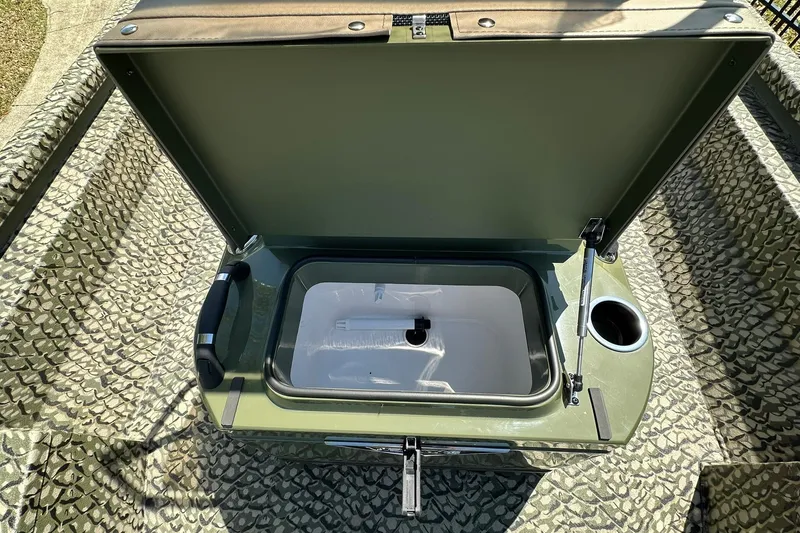 Slide: The Image of Open storage compartment in 2026 Vexus ACX 2000 boat, featuring camouflage interior design. - 17