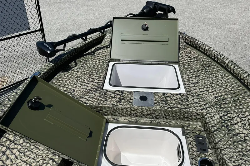 Slide: The Image of 2026 Vexus ACX 2000 boat deck with open storage compartments and camouflage pattern. - 21