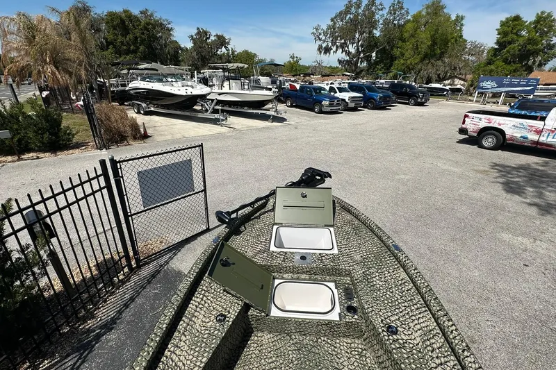 Slide: The Image of 2026 Vexus ACX 2000 boat in parking lot with trucks and trailers nearby. - 22