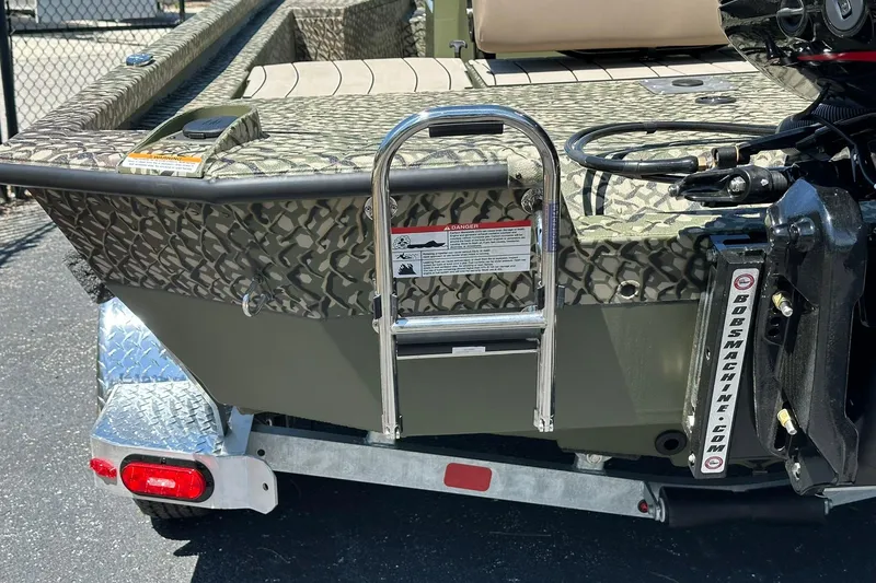 Slide: The Image of 2026 Vexus ACX 2000 boat with camouflage design and rear ladder on trailer. - 27