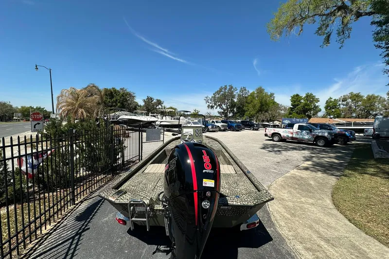 Slide: The Image of 2026 Vexus ACX 2000 boat with powerful engine in a sunny parking lot. - 29