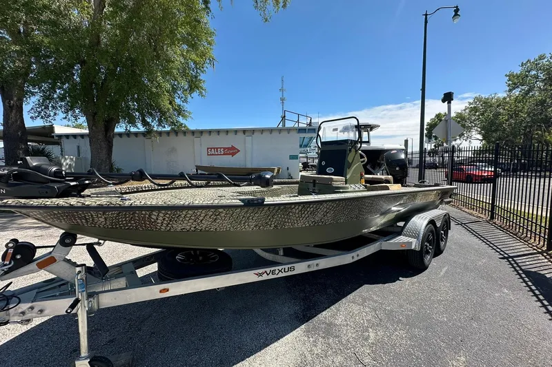 Slide: The Image of 2026 Vexus ACX 2000 boat on trailer, parked outdoors near sales building. - 3