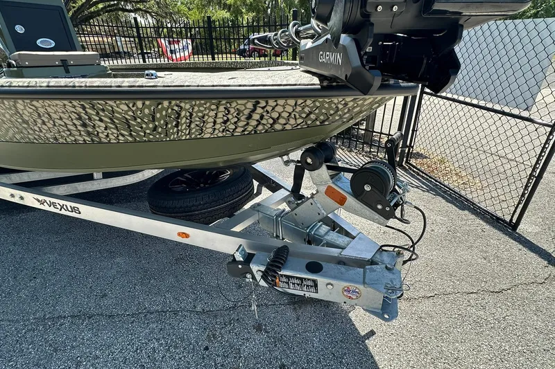 Slide: The Image of 2026 Vexus ACX 2000 boat on trailer with Garmin equipment, parked outdoors. - 31
