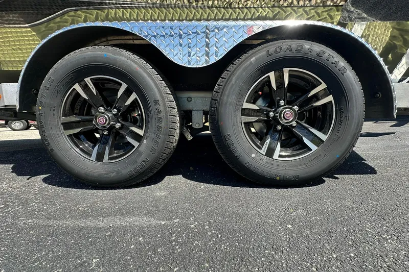 Slide: The Image of Close-up of 2026 Vexus ACX 2000 trailer wheels with Loadstar tires on asphalt. - 32
