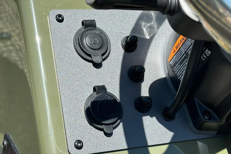 Slide: The Image of Control panel of 2026 Vexus ACX 2000 boat with 12V outlets and warning label. - 8
