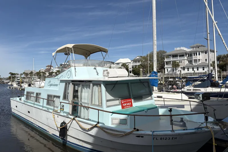 The Image of 1972 Whitcraft Hatteras boat docked, light blue, "For Sale" sign displayed. - 1