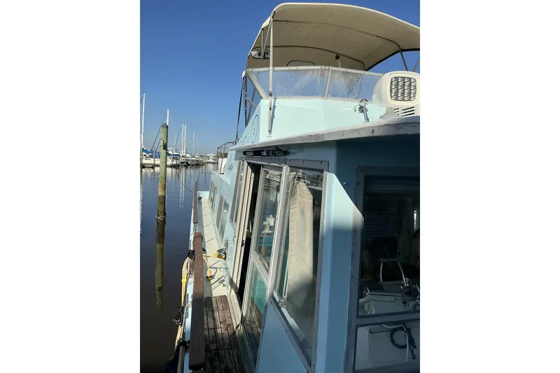 Slide: The Image of 1972 Whitcraft Hatteras boat docked at marina under clear blue sky. - 12
