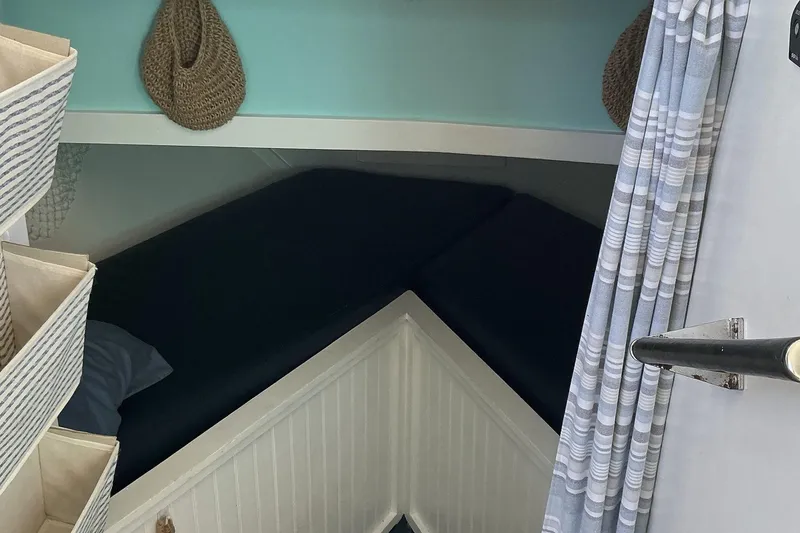 Slide: The Image of Cozy cabin interior of 1972 Whitcraft Hatteras boat with striped storage and curtains. - 22