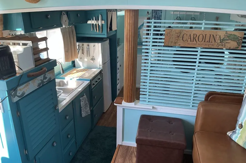 Slide: The Image of Interior of a 1972 Whitcraft Hatteras boat with a cozy kitchen and seating area. - 25