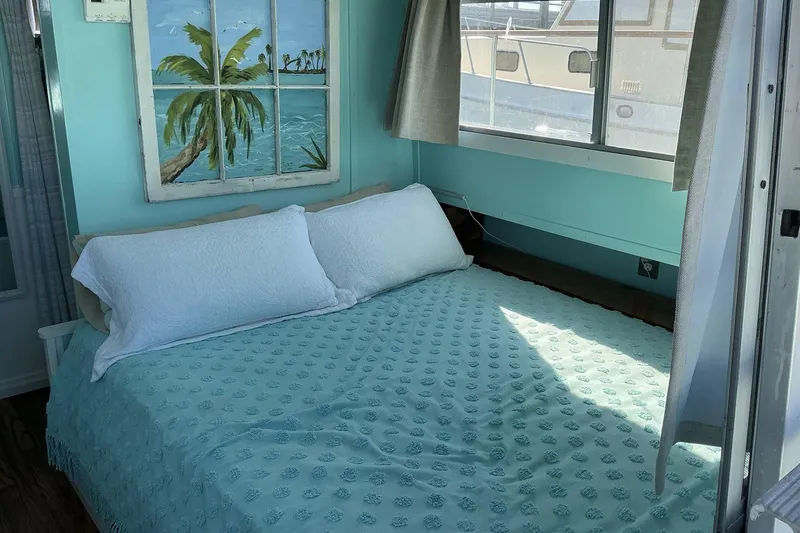 Slide: The Image of Cozy bedroom in 1972 Whitcraft Hatteras boat with ocean-themed decor. - 33