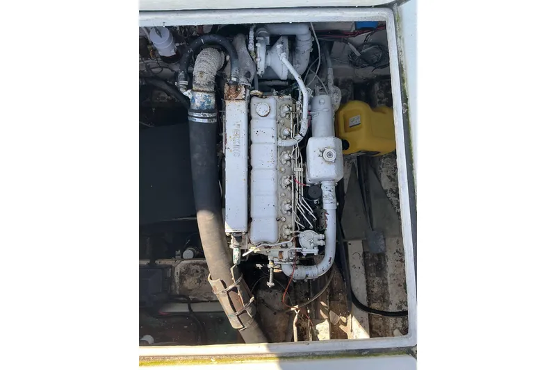 Slide: The Image of 1972 Whitcraft Hatteras engine compartment with visible components and hoses. - 35