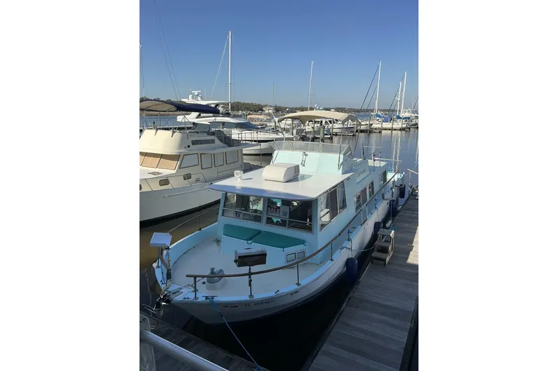 Slide: The Image of 1972 Whitcraft Hatteras boat docked at marina under clear blue sky. - 5