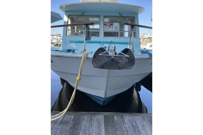 Slide: The Image of 1972 Whitcraft Hatteras boat docked, front view, with "For Sale" sign displayed. - 7