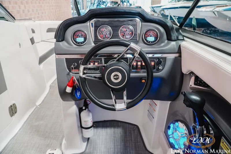 Slide: The Image of 2017 Chaparral 246 SSi boat dashboard with steering wheel and control panel. - 10