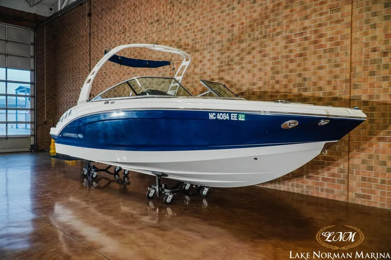 Slide: The Image of 2017 Chaparral 246 SSi boat in showroom, blue and white exterior, Lake Norman Marina. - 3